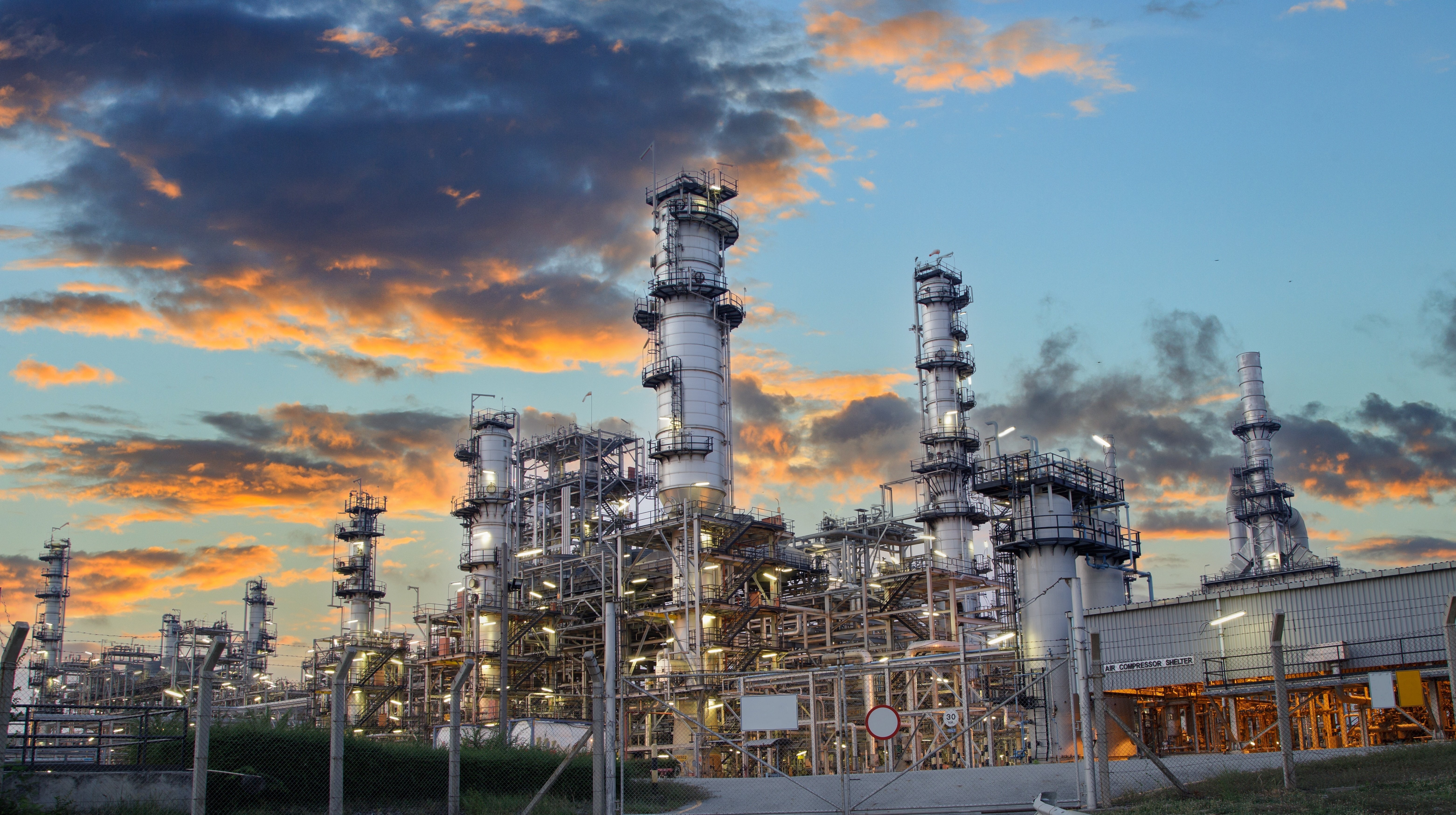 Oil and gas processing facility at sunset